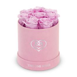 Pink roses arranged in a round pink hat box