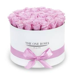 Round box of pink roses with a pink ribbon bow
