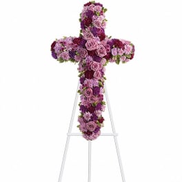 Purple floral cross on a white easel