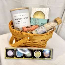Gift basket with candles, soap, bath salts, and lip balm