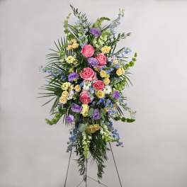 Tall standing floral spray with pink, purple, yellow, and blue flowers