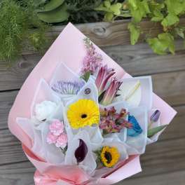 Pastel bouquet with mixed flowers wrapped in pink paper