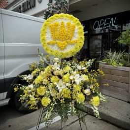 Yellow and white floral standing tribute on an easel
