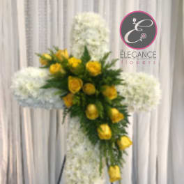 Yellow roses on a white floral cross stand arrangement