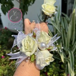 White rose corsage with pearl accents and sheer ribbon