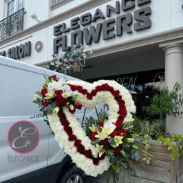 Heart-shaped floral standing spray with red roses and white blooms