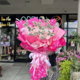 Large pink bouquet wrapped with Hermes paper and dollar-bill butterflies