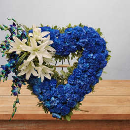 Blue floral heart wreath with white lilies and purple orchids