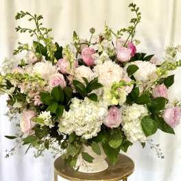 Pink and white floral arrangement in a white vase