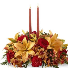 Autumn floral centerpiece with two red taper candles