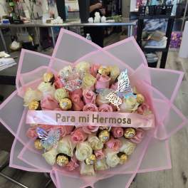 Pink and cream rose bouquet with chocolates and butterfly decorations