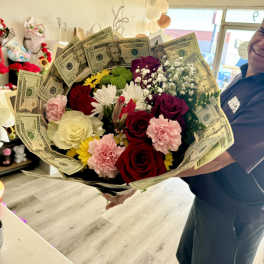 Bouquet of mixed flowers wrapped with U.S. dollar bills