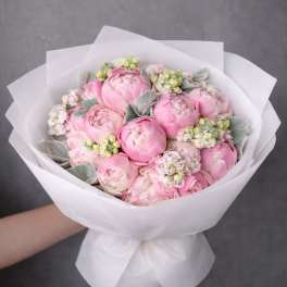 Pink peony bouquet wrapped in white paper