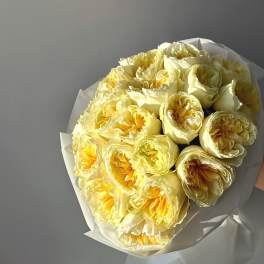 Bouquet of pale yellow roses wrapped in white paper