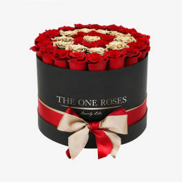 Round box of red and cream roses with a ribbon bow