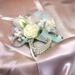 White rose corsage with pearl bracelet and silver ribbon