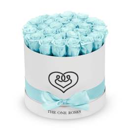 Light blue roses in a round white hat box with a ribbon