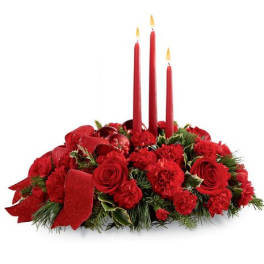 Red floral centerpiece with three lit taper candles
