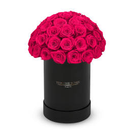 Round bouquet of hot pink roses in a black hat box