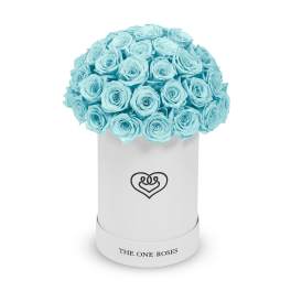 Bouquet of light blue roses in a white cylindrical box