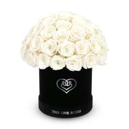 White roses arranged in a black round box