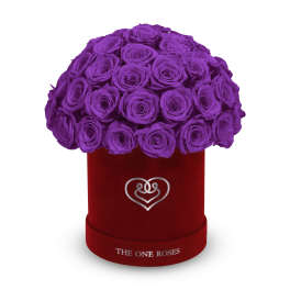 Purple roses arranged in a red round box with a heart emblem