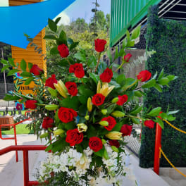 Tall standing floral spray with red roses, white blooms, and lilies