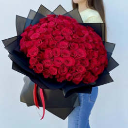 Large bouquet of red roses wrapped in black paper