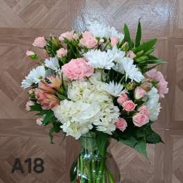 Pink and white bouquet in a glass vase