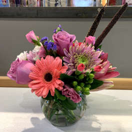 Pink and purple mixed bouquet in a clear glass vase