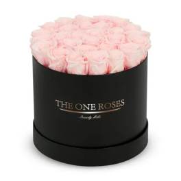 Pink roses arranged in a black round box