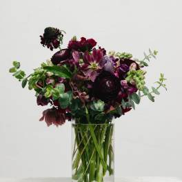Dark burgundy bouquet in a clear glass vase