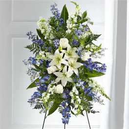 Tall white and blue floral standing spray on an easel
