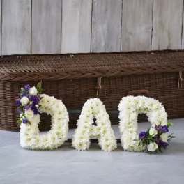 Floral letters spelling DAD with white and purple flowers
