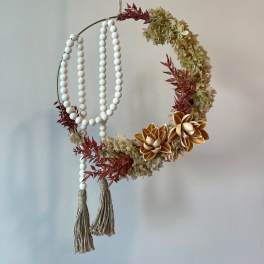 Circular hanging floral hoop with cream blooms and white bead strands
