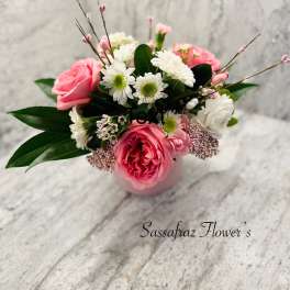 Pink and white flower arrangement in a small vase