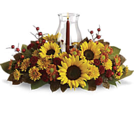 Sunflower and autumn floral centerpiece with a glass hurricane candle holder