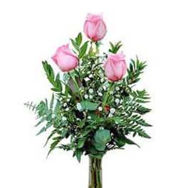 Pink roses in a clear glass vase with greenery