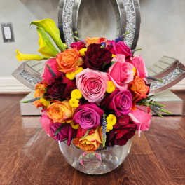 Bright mixed rose bouquet in a clear glass vase