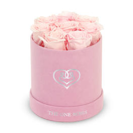 Pink roses arranged in a round pink hat box