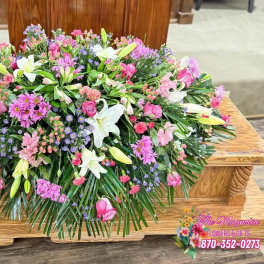 Large pink and white floral casket spray with lilies and roses