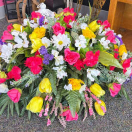 Large mixed floral arrangement with pink, yellow, white, and purple flowers