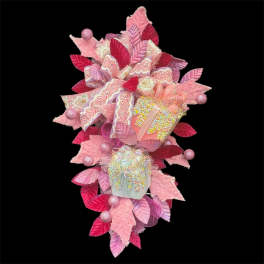 Pink decorative gift arrangement with ribbons and faux leaves