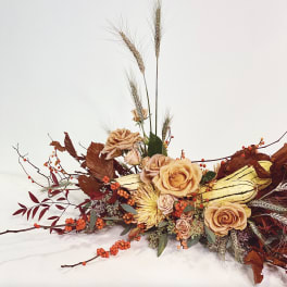 Autumn floral arrangement with peach roses and wheat stalks