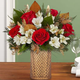 Red roses and white lilies in a textured gold vase