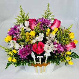 Mixed bouquet of roses, chrysanthemums, and alstroemeria in a white container