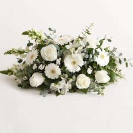 White roses and daisy-like flowers in a low arrangement