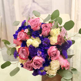 Bouquet of pink and cream roses with purple flowers and eucalyptus