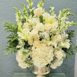 Creamy white floral arrangement in a silver vase