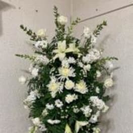 Tall white floral standing spray on an easel
